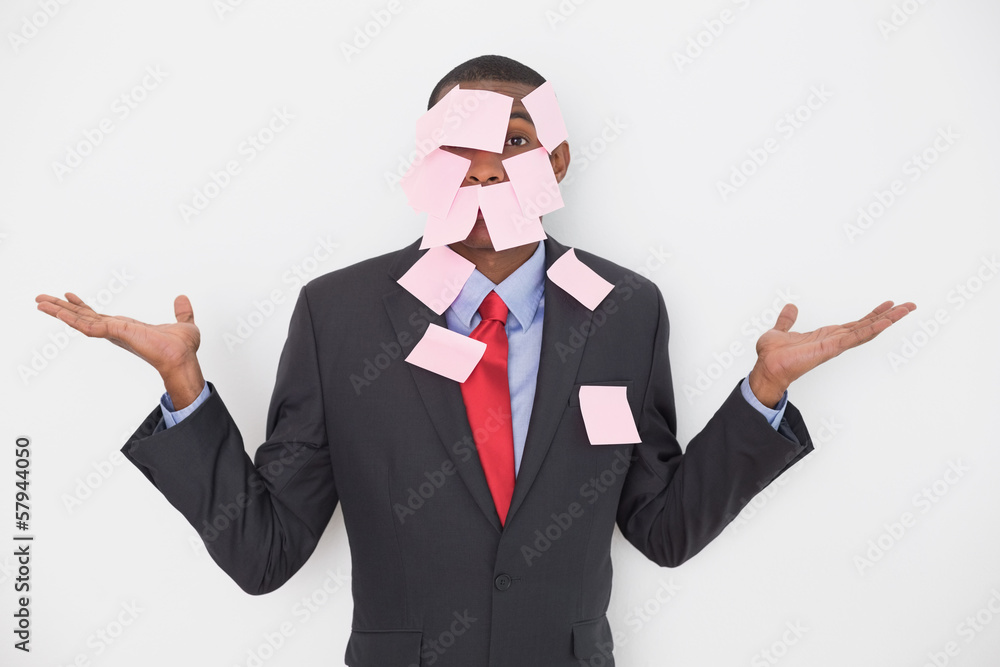 Portrait of an Afro businessman covered in blank notes Portrait of an Afro businessman covered in blank notes