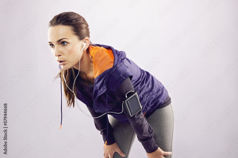 Young woman in sportswear relaxing after a jog Young woman in sportswear relaxing after a jog