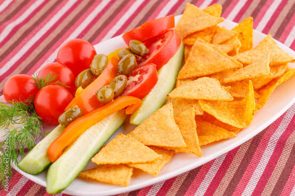 Vegetables, olives, nachos in plate Vegetables, olives, nachos in plate