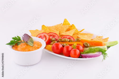 Vegetables, olives, nachos, red and cheese sause photo