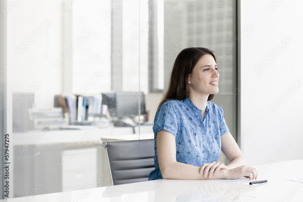 Obraz premium Businesswoman sitting and listening during a business meeting