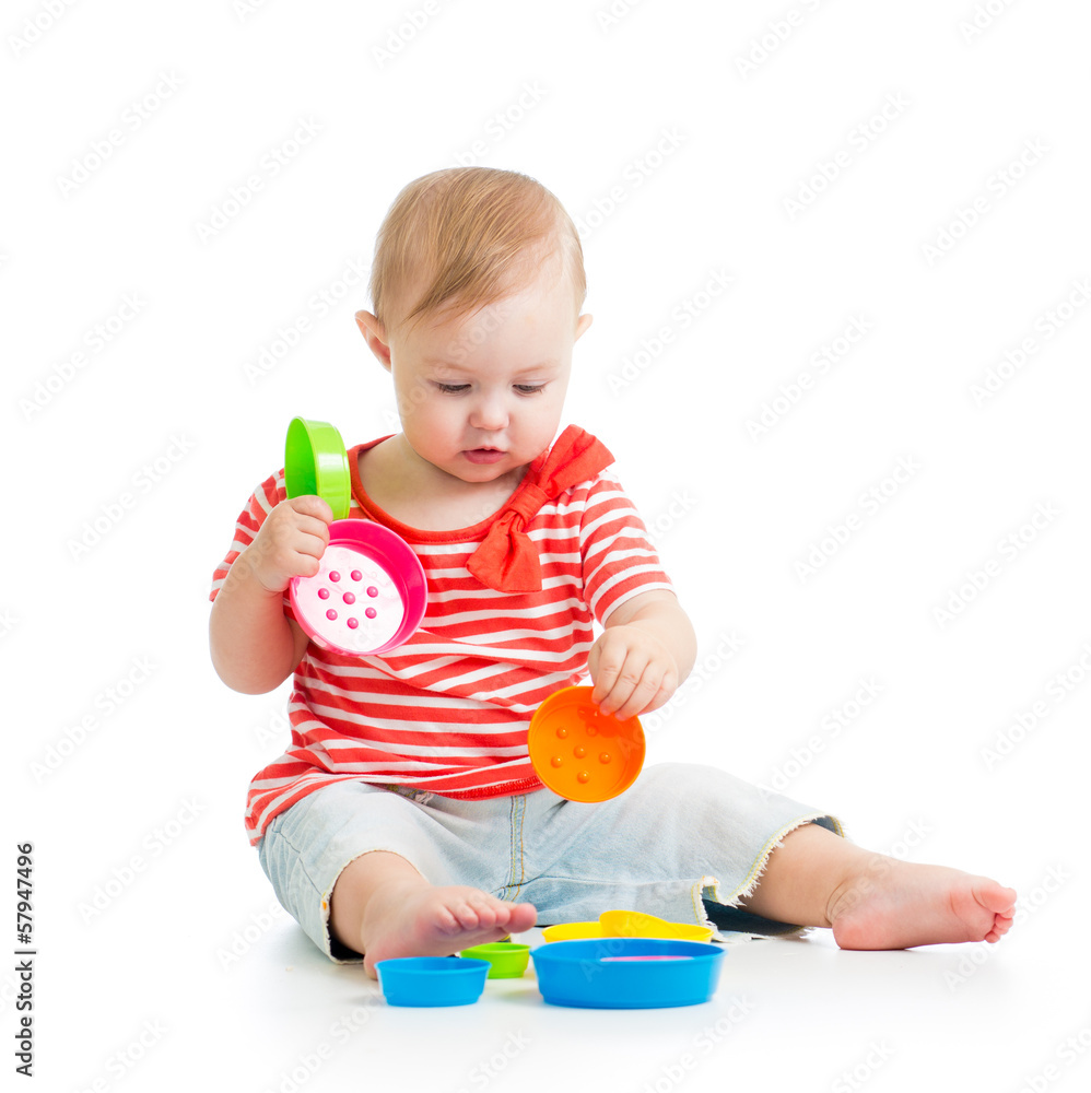 Funny little child is playing with toys while sitting on floor, Funny little child is playing with toys while sitting on floor,