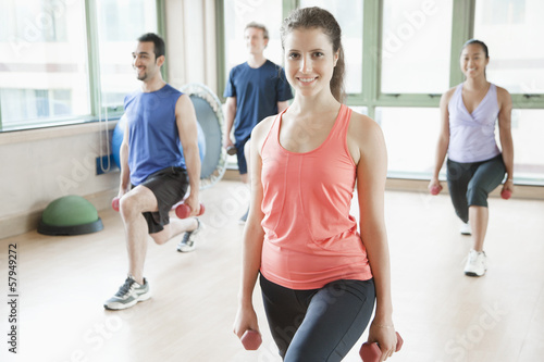 Four people stretching in aerobics class