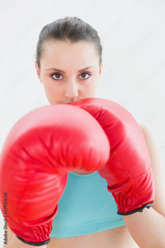 Close up of beautiful woman in red boxing gloves Close up of beautiful woman in red boxing gloves