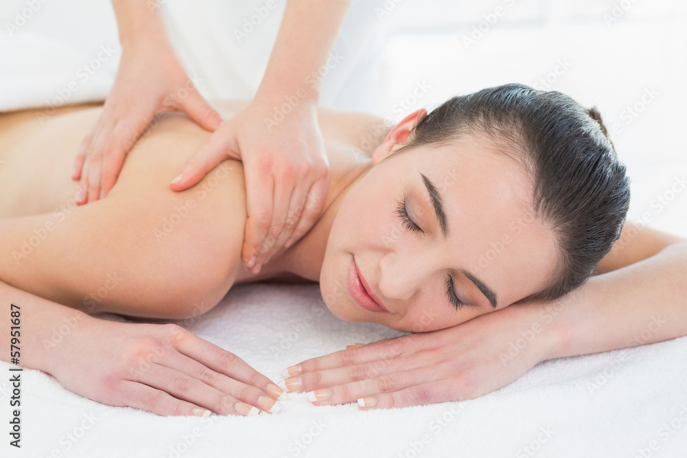 Beautiful woman enjoying back massage at beauty spa Beautiful woman enjoying back massage at beauty spa