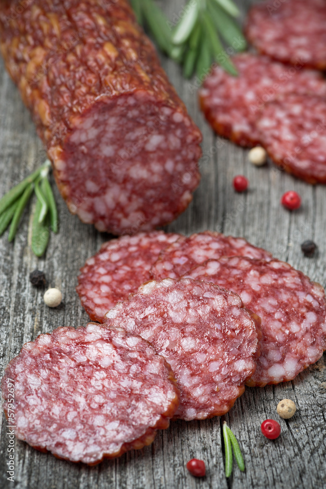 salami and spices on a wooden table salami and spices on a wooden table