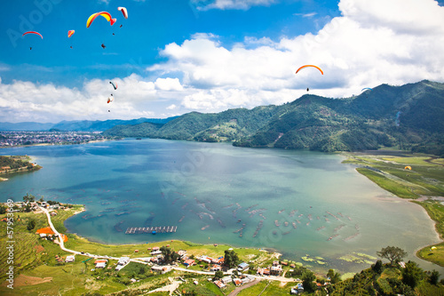 Paraglider flying over the  Fewa lake in Pokhara, Nepal. photo