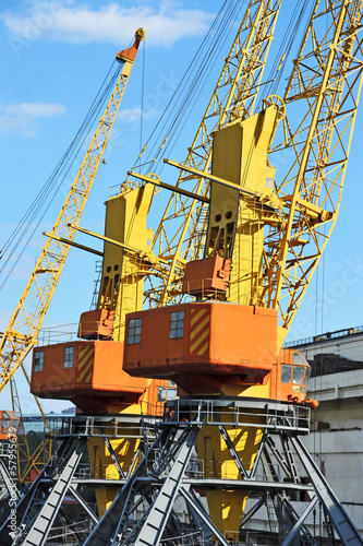 Port cargo crane over blue sky background