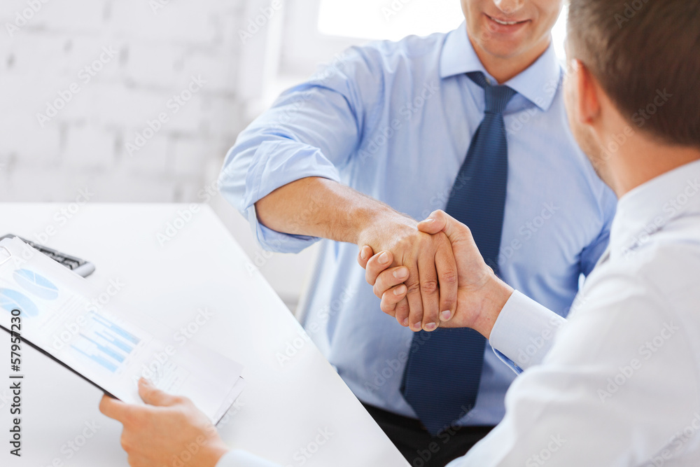 businessmen shaking hands in office businessmen shaking hands in office