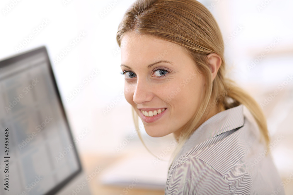 Portrait of beautiful office-worker sitting at desk Portrait of beautiful office-worker sitting at desk
