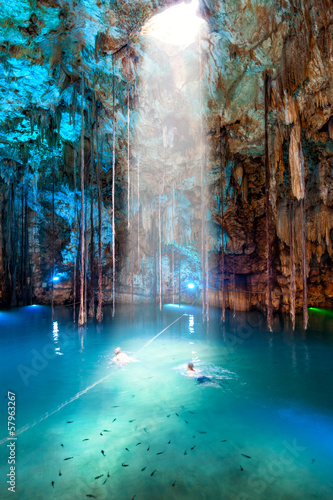Cenote Dzitnup  Mexico. Blurred couple swimming