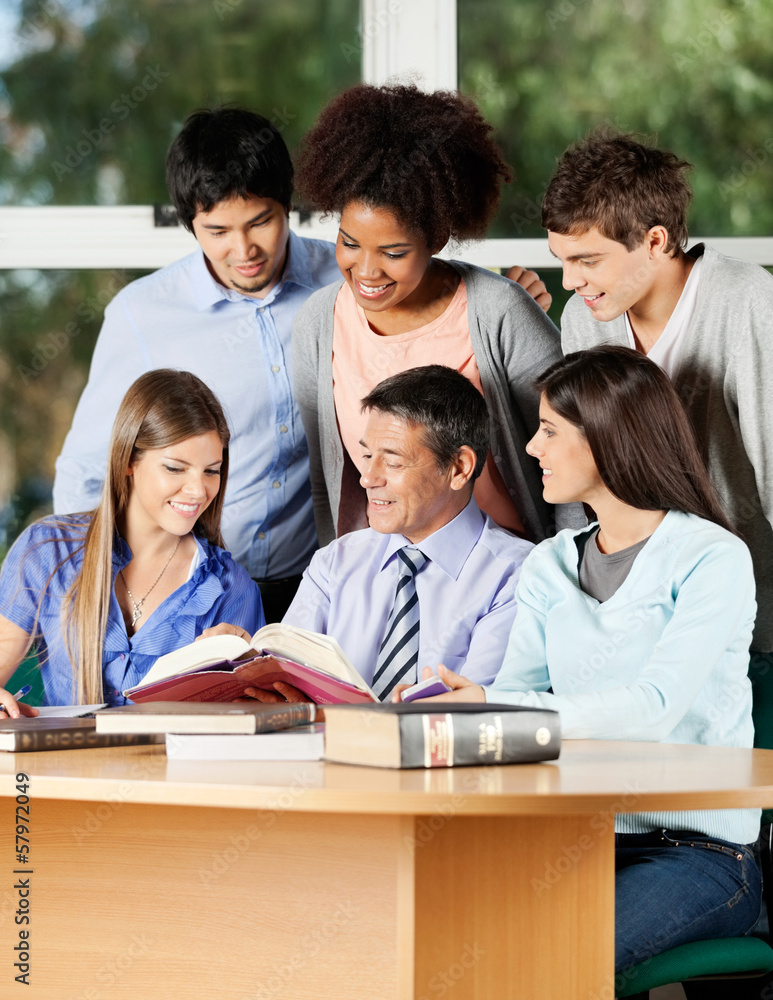 Professor Explaining Students At Desk In Classroom Professor Explaining Students At Desk In Classroom
