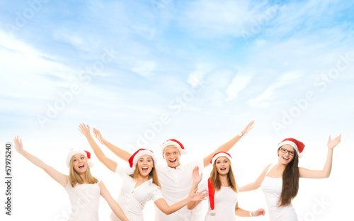 A group of happy and emotional teenagers in Christmas hats