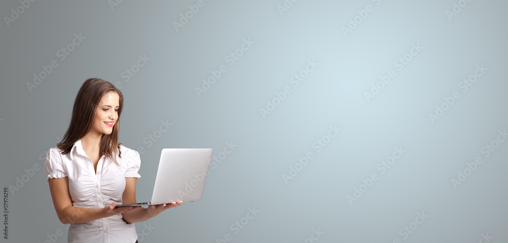 attractive woman holding a laptop with copy space attractive woman holding a laptop with copy space
