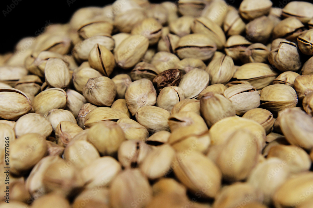 tasty looking pistachio nuts still in their shells. tasty looking pistachio nuts still in their shells.