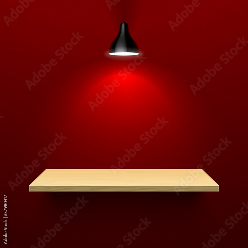 Wooden shelf illuminated by lamp