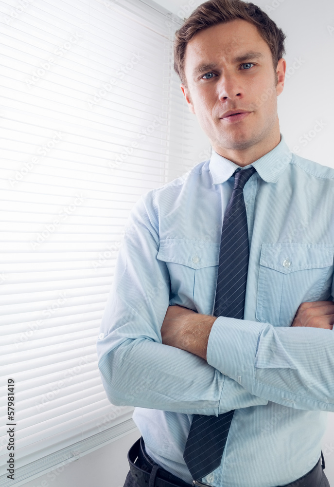 Elegant businessman with arms crossed in office Elegant businessman with arms crossed in office
