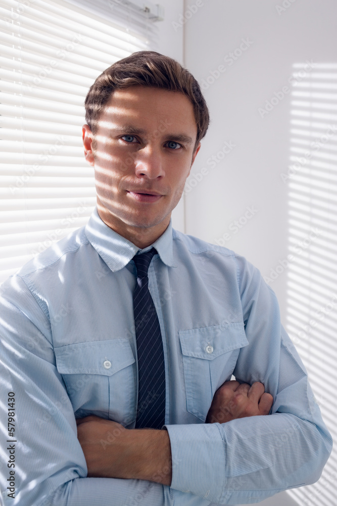 Elegant businessman with arms crossed in office Elegant businessman with arms crossed in office