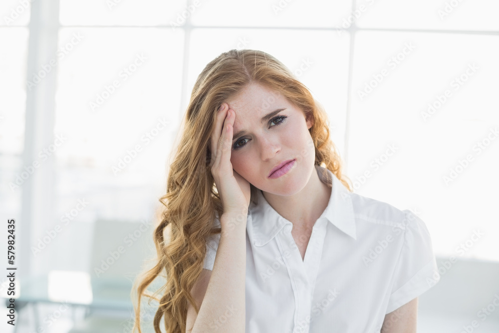 Elegant businesswoman suffering from headache in office Elegant businesswoman suffering from headache in office