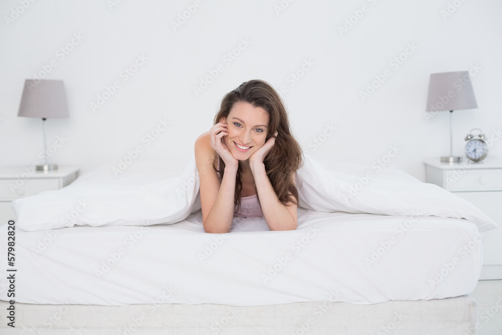 Portrait of a pretty smiling woman resting in bed Portrait of a pretty smiling woman resting in bed