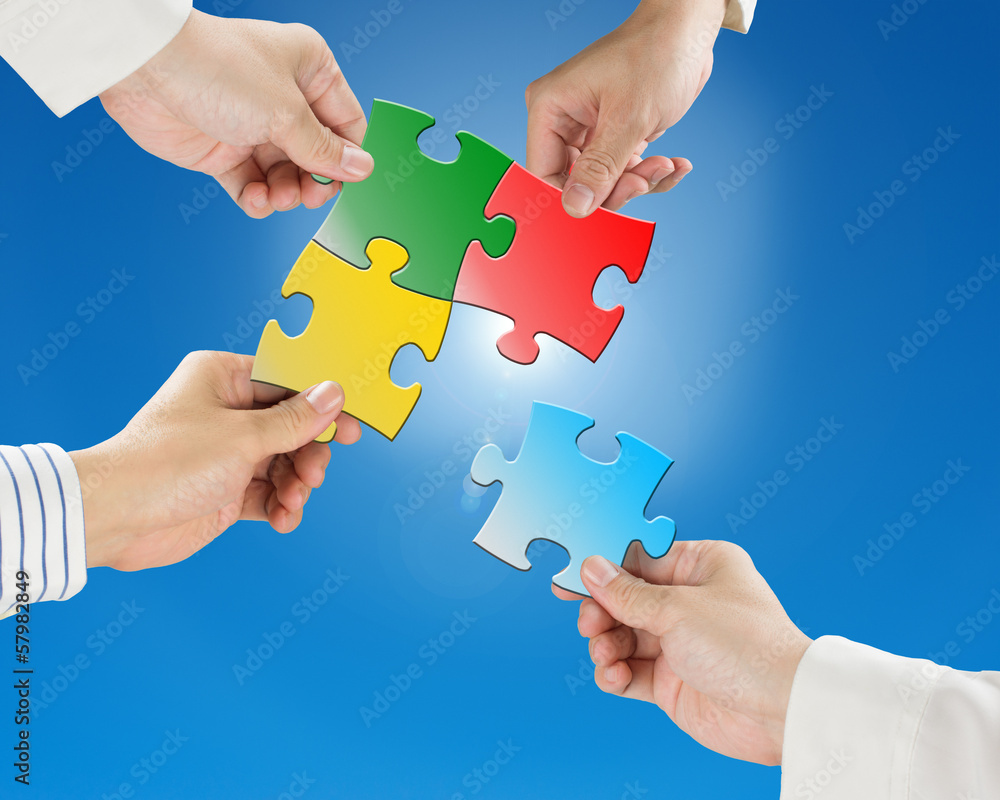 Team work concept, Hands hold puzzles with clear blue sky and su Team work concept, Hands hold puzzles with clear blue sky and su