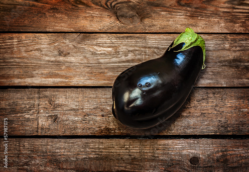 Eggplant on vintage wood background with text space