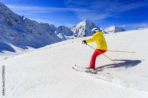 Ski, skier on ski run - woman skiing downhill