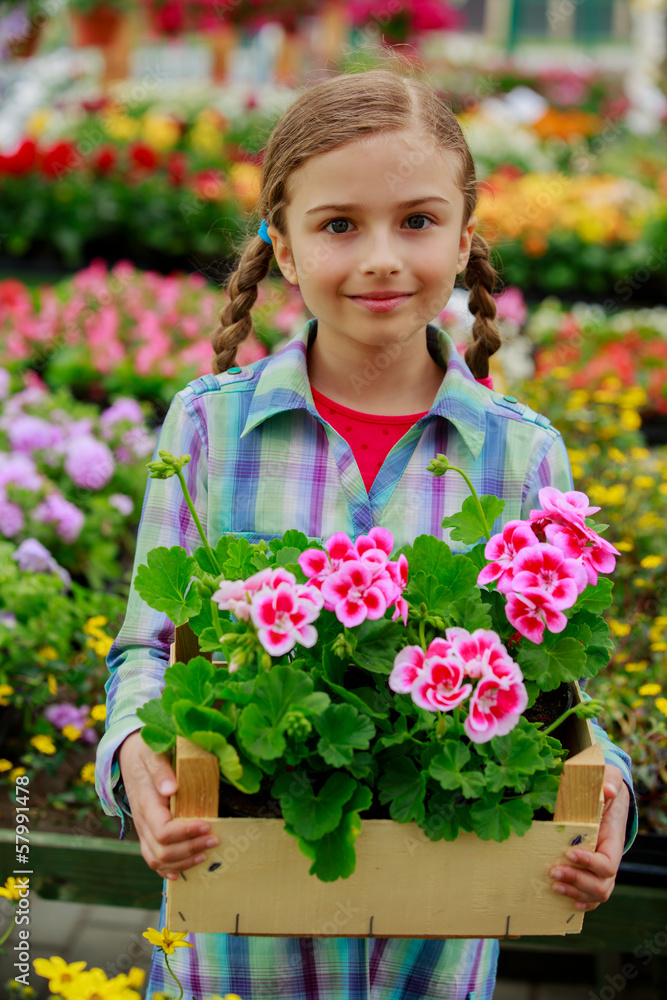 Gardening - girl holding flowers in garden center Gardening - girl holding flowers in garden center