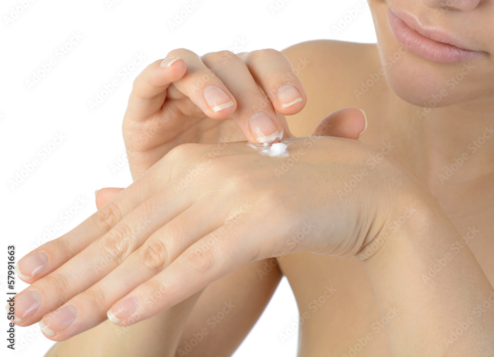 Fototapeta premium Junge Frau trägt Handcreme auf