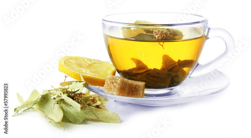 Transparent cup of herbal tea with herb isolated on white