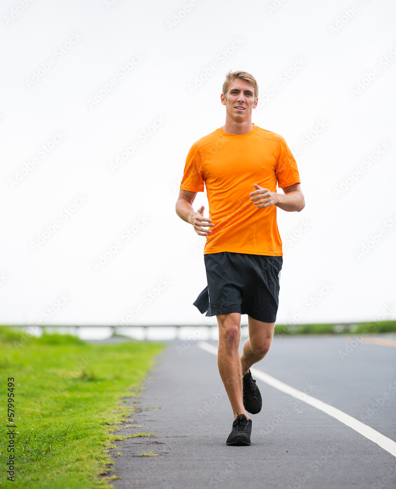 Athletic man running jogging outside
