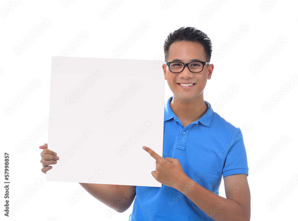 Young man holding blank billboard