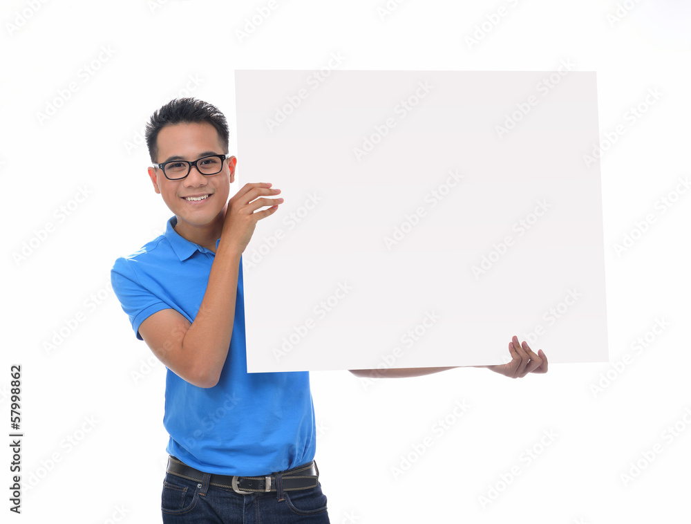 Young man holding blank billboard Young man holding blank billboard