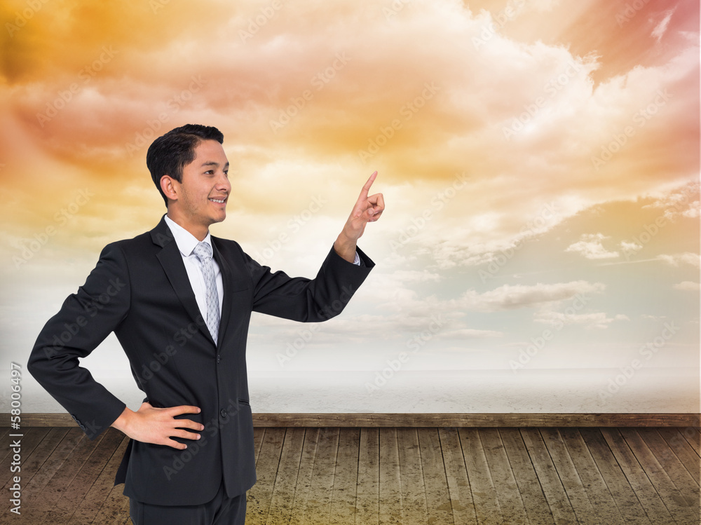 Composite image of smiling asian businessman pointing Composite image of smiling asian businessman pointing