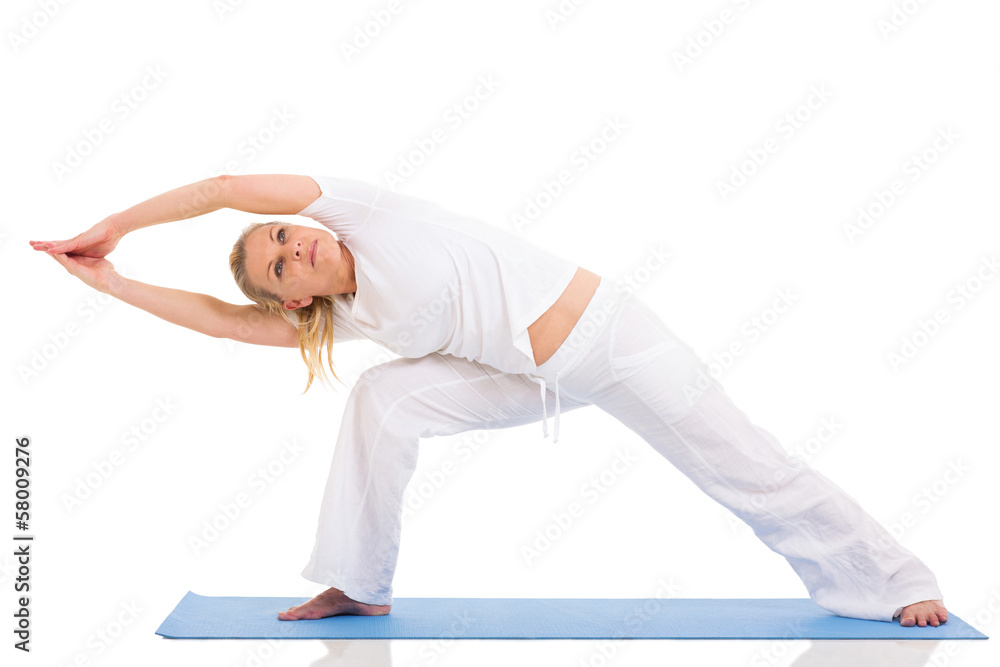 mid age woman doing yoga exercises