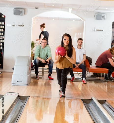 Woman Holding Bowling Ball in Club