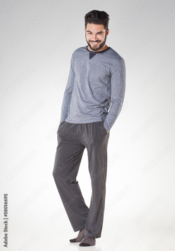 attractive men in pyjamas smiling isolated on grey - studio attractive men in pyjamas smiling isolated on grey - studio