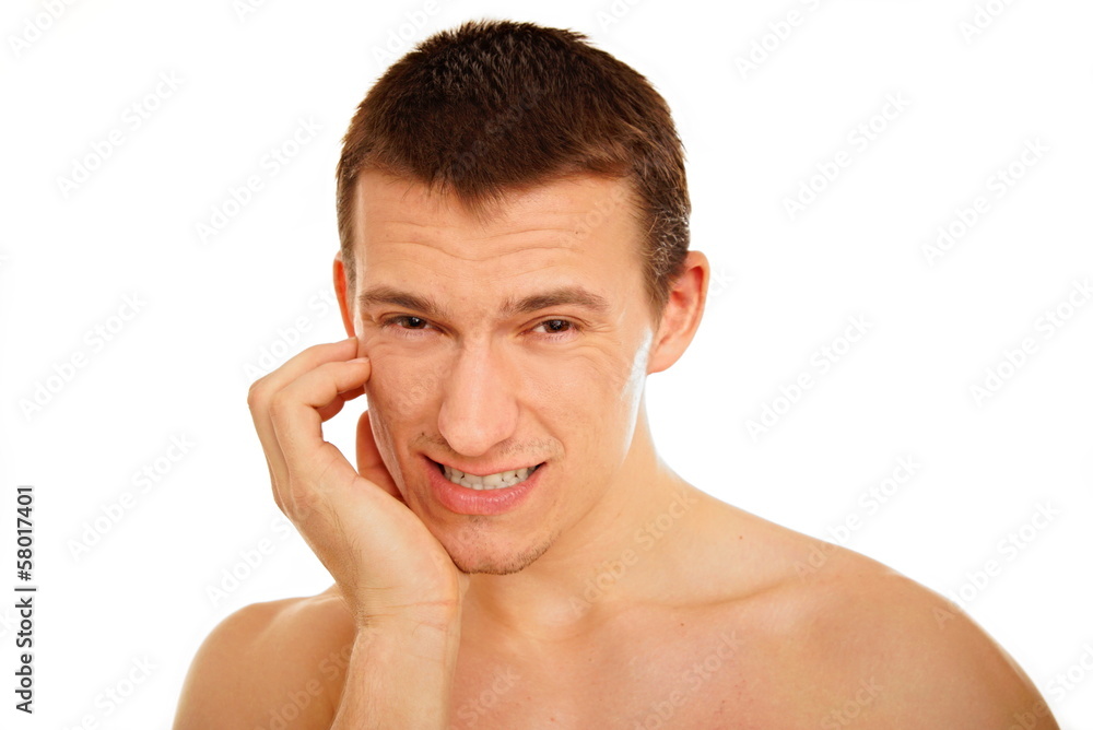 Young man suffering from a toothache on the white background Young man suffering from a toothache on the white background
