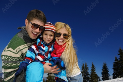 family having fun on fresh snow at winter vacation © .shock