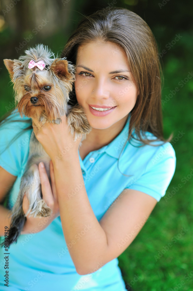 Young beautiful woman holding her puppy dog - outdoor portrait Young beautiful woman holding her puppy dog - outdoor portrait