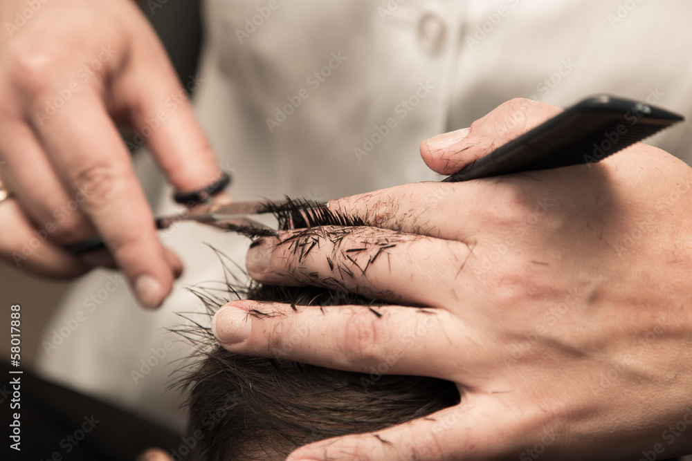 Obraz premium haircut at the barber scissors