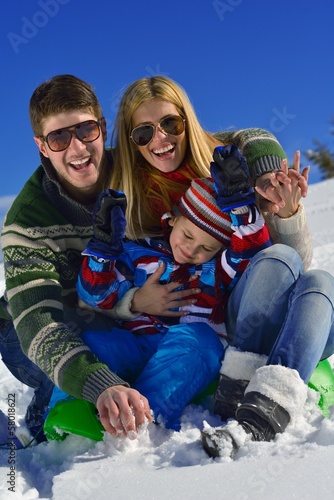 family having fun on fresh snow at winter vacation © .shock