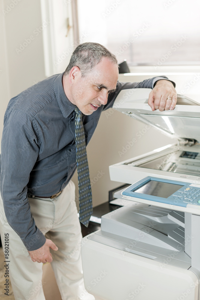 Man having problem with photocopier in office