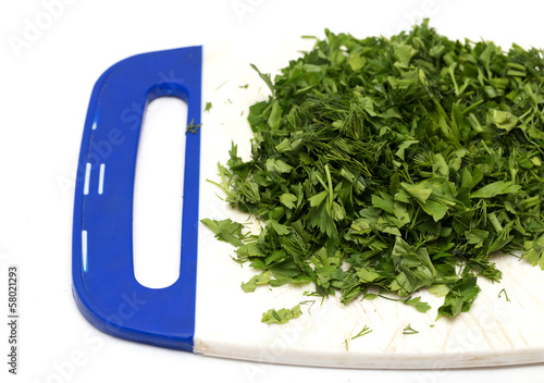 chopped dill parsley on the chopping board photo