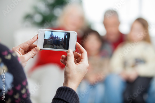 Mother Photographing Family Through Smartphone