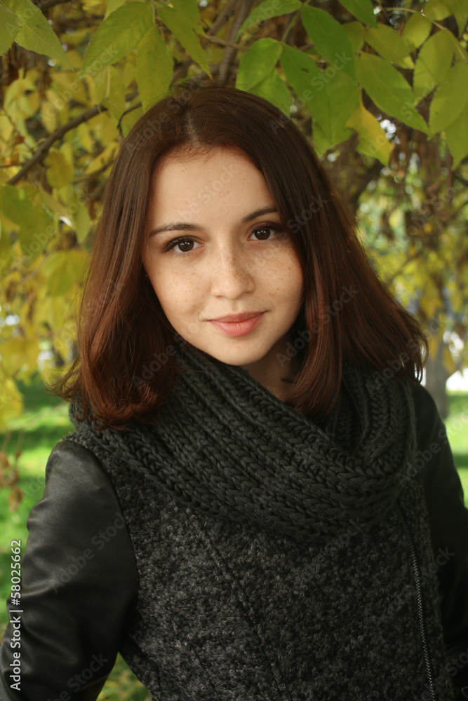 brunette girl with black scarf in the autumn park. brunette girl with black scarf in the autumn park.