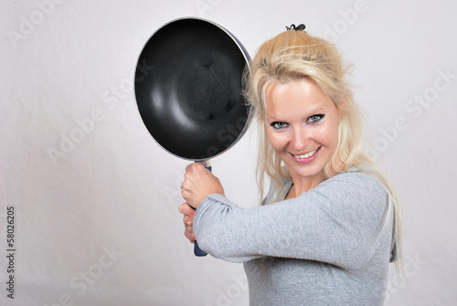 Woman beating with a frying photo