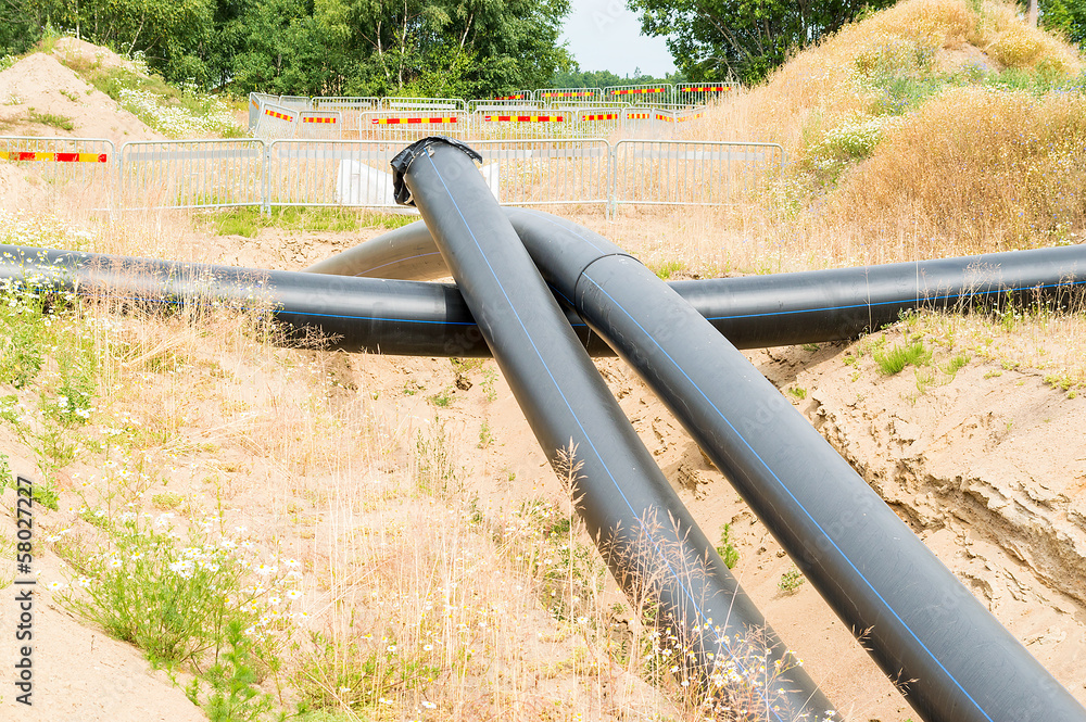 Plastic pipes being placed under ground