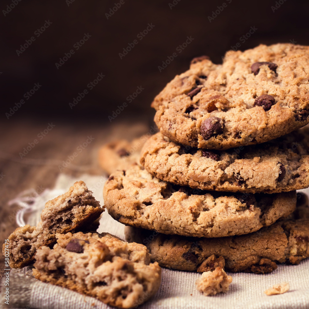 Chocolate chip cookies on wooden background. Stacked chocolate c Chocolate chip cookies on wooden background. Stacked chocolate c