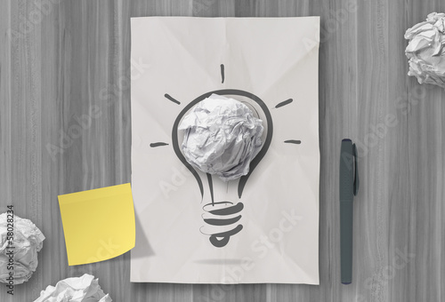 sticky note with another idea light bulb on crumpled paper as cr